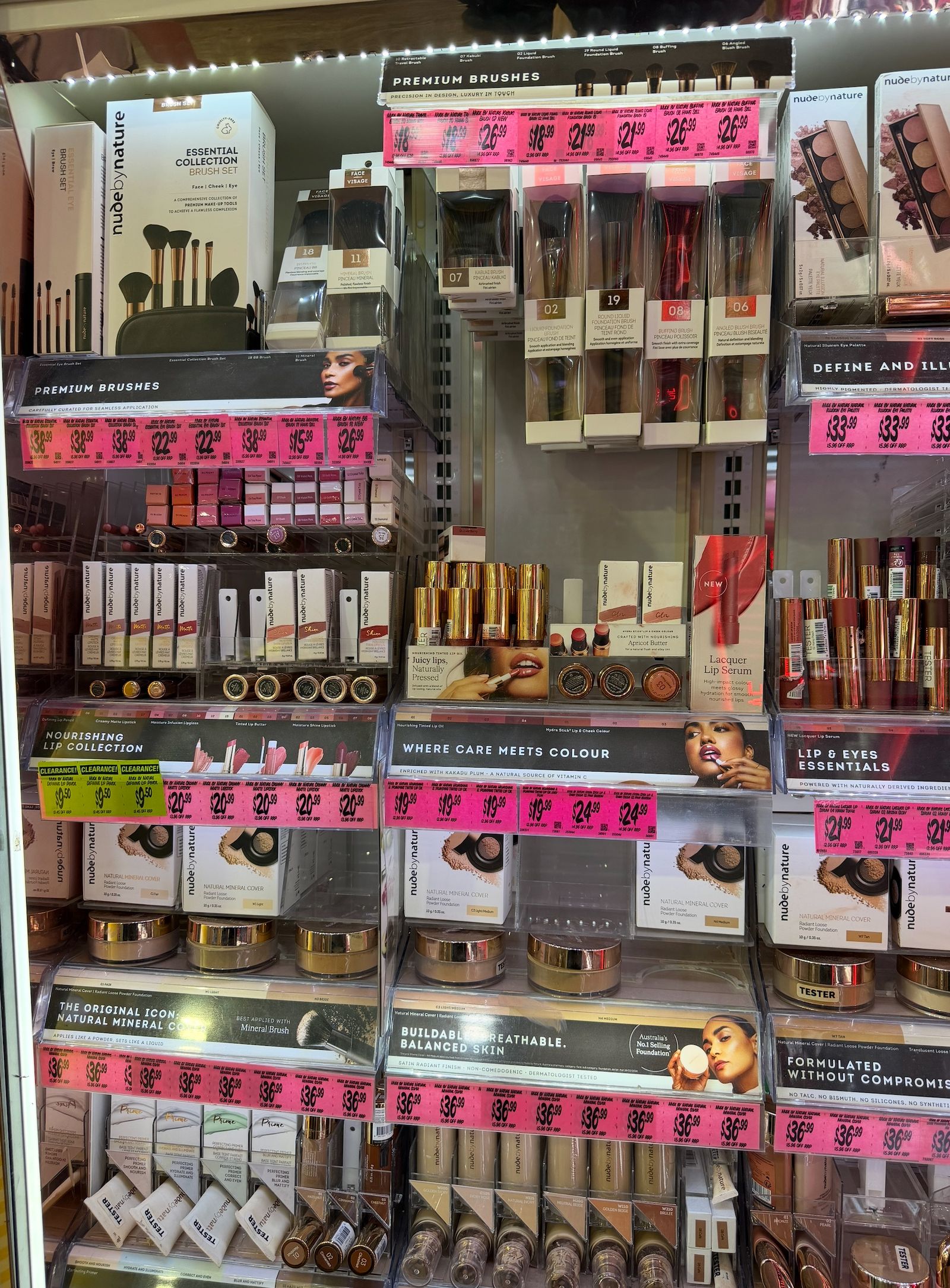 A retail cosmetics bay with product facings, labels and shelf-edge pricing